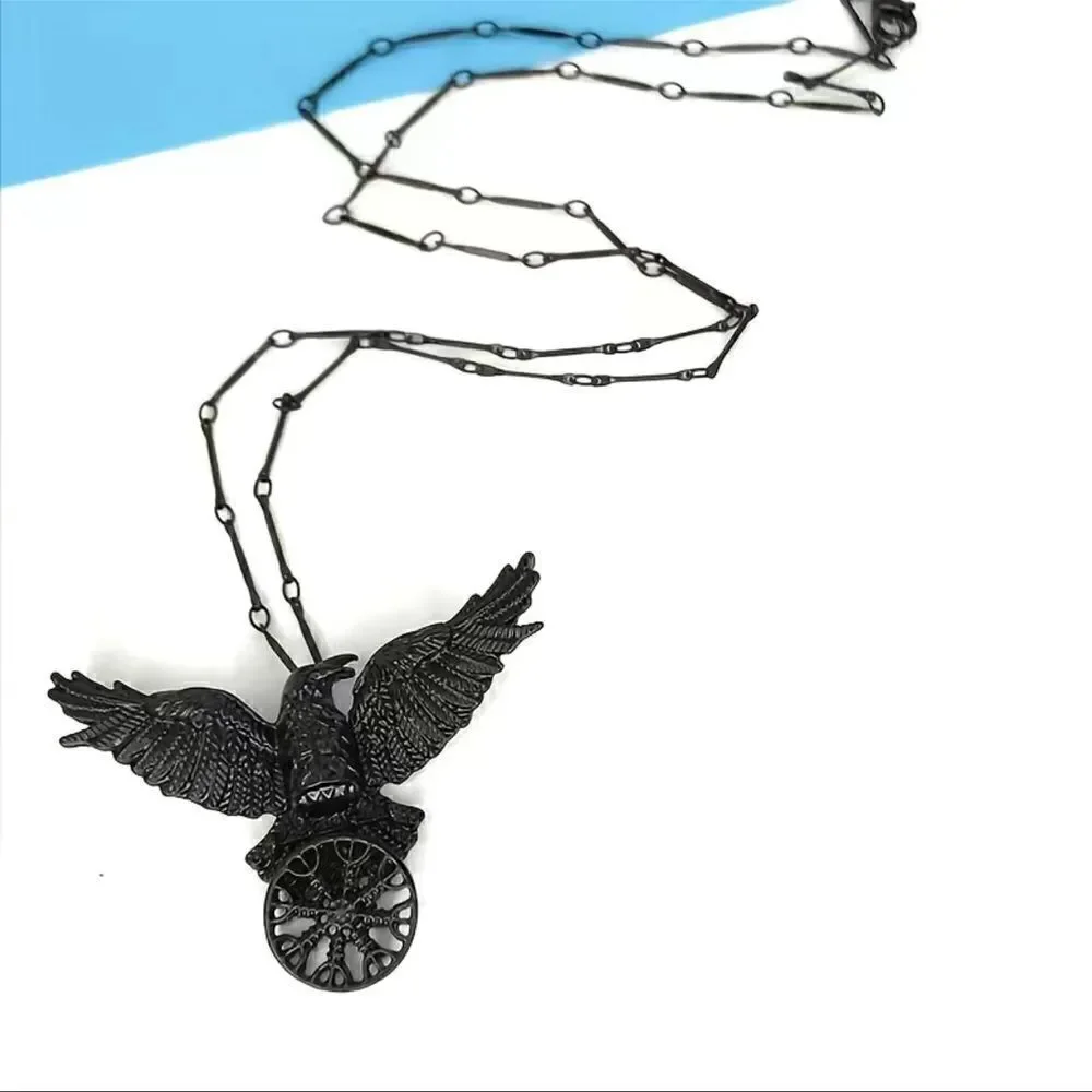 Black raven pendant necklace with black link chain.
